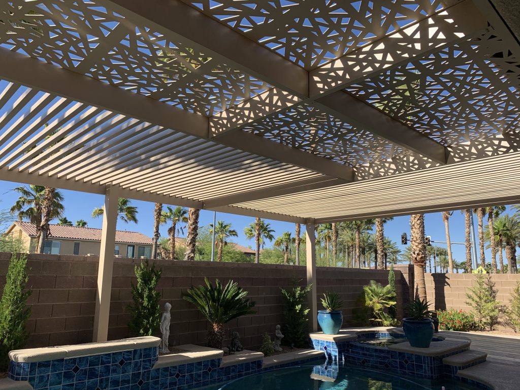 Tan aluminum pergola and shade structure with decorative panels